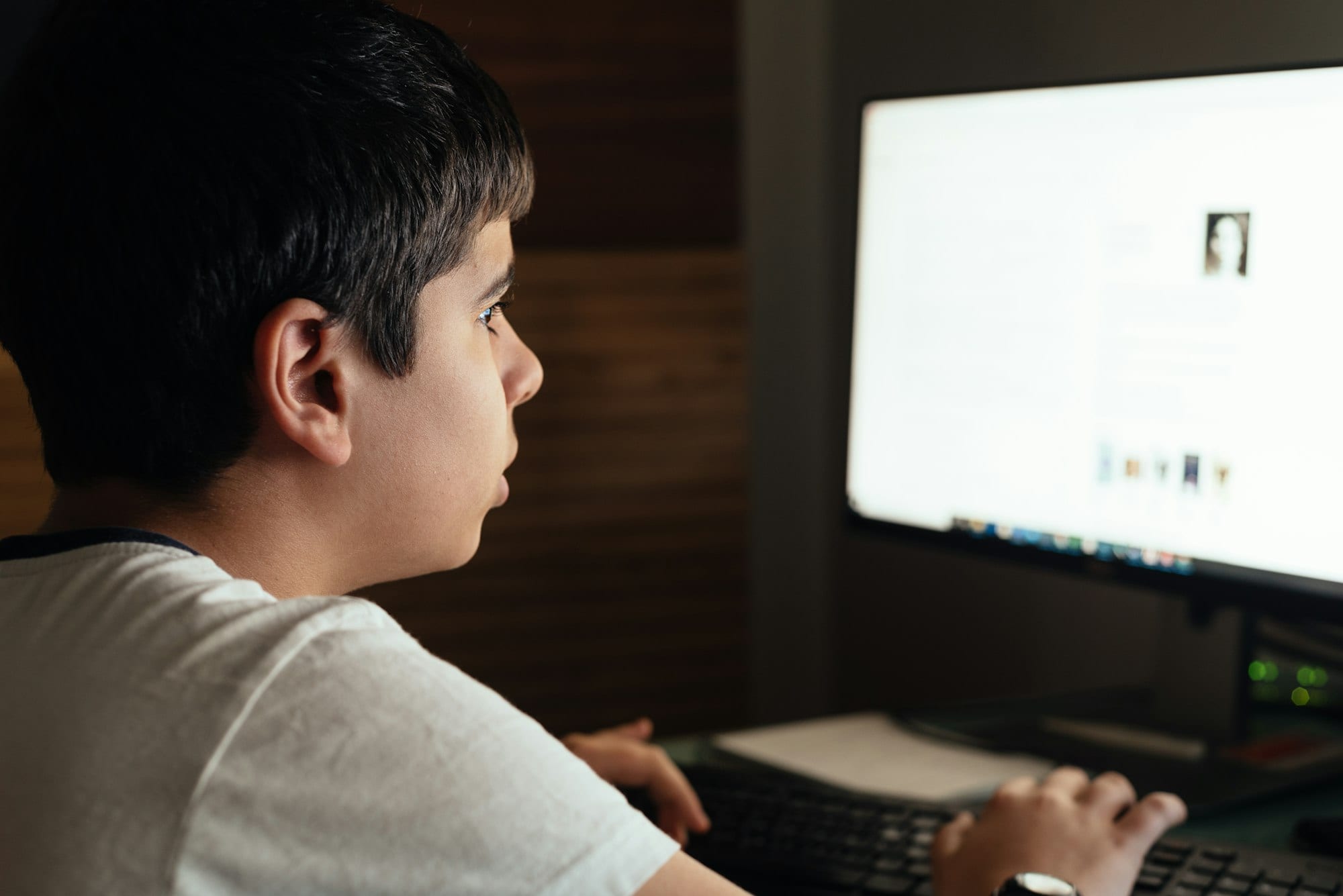 Teenager concentrated studying at home attending online classes