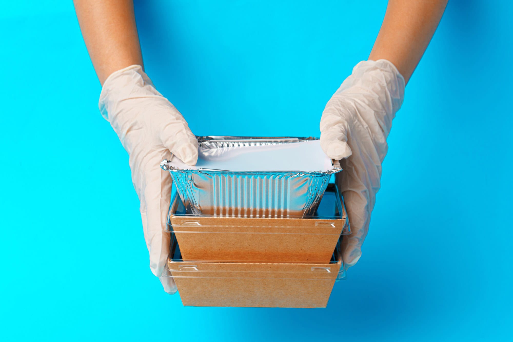 Delivery man hands giving food containers and packages